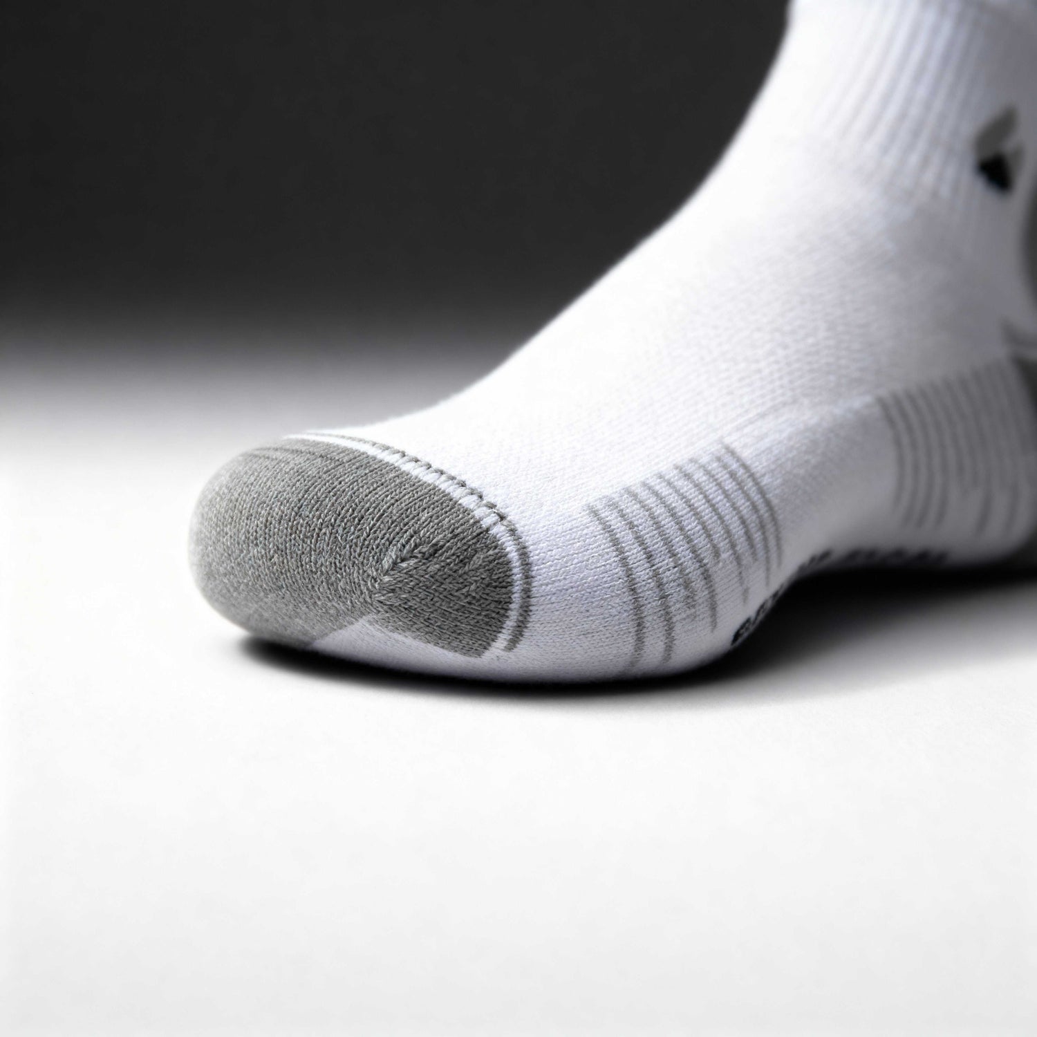 White and grey ankle running socks with moisture-wicking fabric and seamless toe design